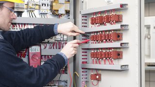 electrician testing industrial machine