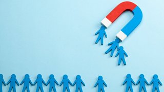 Personnel recruitment and a magnet attracts good employee leaders. Blue background Personnel recruitment and a magnet attracts good employee leaders. Blue background