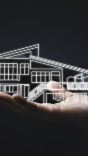 Business holding virtual infographic house on hand. Real estate investment concept.