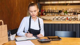 small restaurant owner calculating expenses small restaurant owner calculating expenses