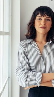 Confident female architect standing in office