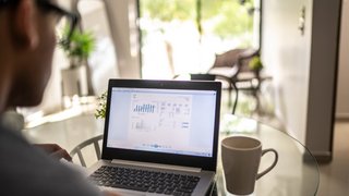 Man analyzing his investments in laptop at home