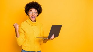 Portrait of her she nice attractive lovely charming smart clever cheerful wavy-haired girl holding in hands laptop celebrating winning isolated over bright vivid shine vibrant yellow color background Portrait of her she nice attractive lovely charming smart clever cheerful wavy-haired girl holding in hands laptop celebrating winning isolated over bright vivid shine vibrant yellow color background