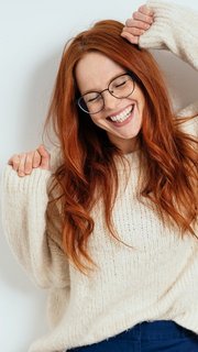 Merry young woman celebrating and dancing