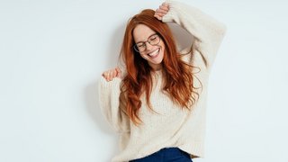 Merry young woman celebrating and dancing