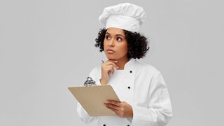 thinking female chef with clipboard and pen thinking female chef with clipboard and pen