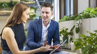 Caucasian business people is working on new strategic planning for next year using laptop while working in green building eco friendly modern working space surrounded by air purifying house plant