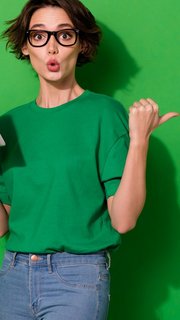 Photo of charming impressed woman dressed summer t-shirt eyewear typing gadget empty space isolated green color background