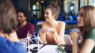 Young coworkers talking at conference table