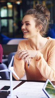 Young coworkers talking at conference table